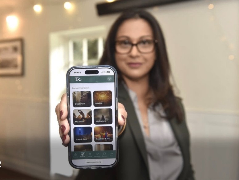 Darshana holding the Teacher Restore app, featured in The News, Portsmouth